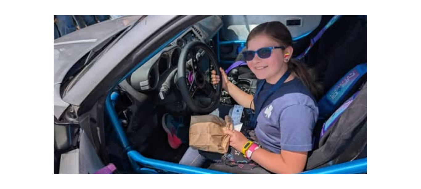 Girl Guide checking out the inside of Cassandra Ebner's Drift Car.